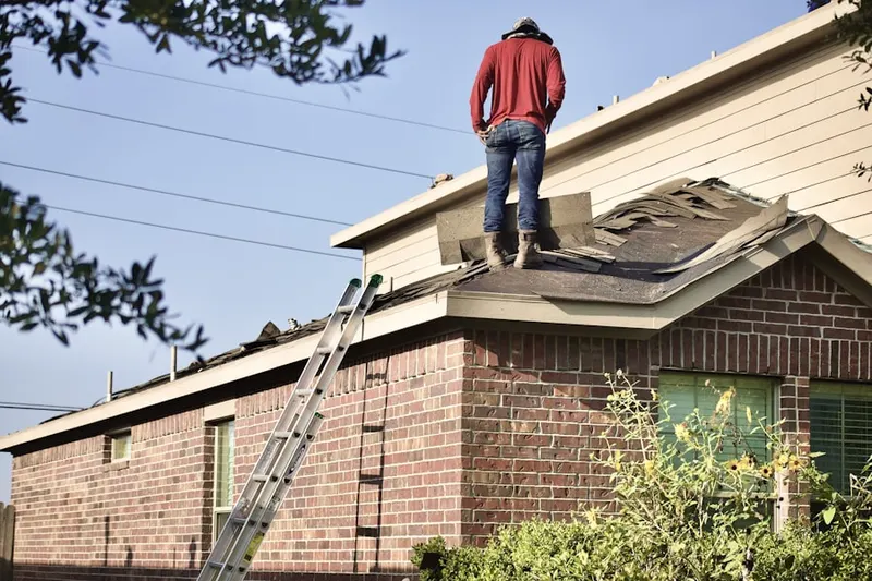 Professional roofer working on a residential roof in Glyndon